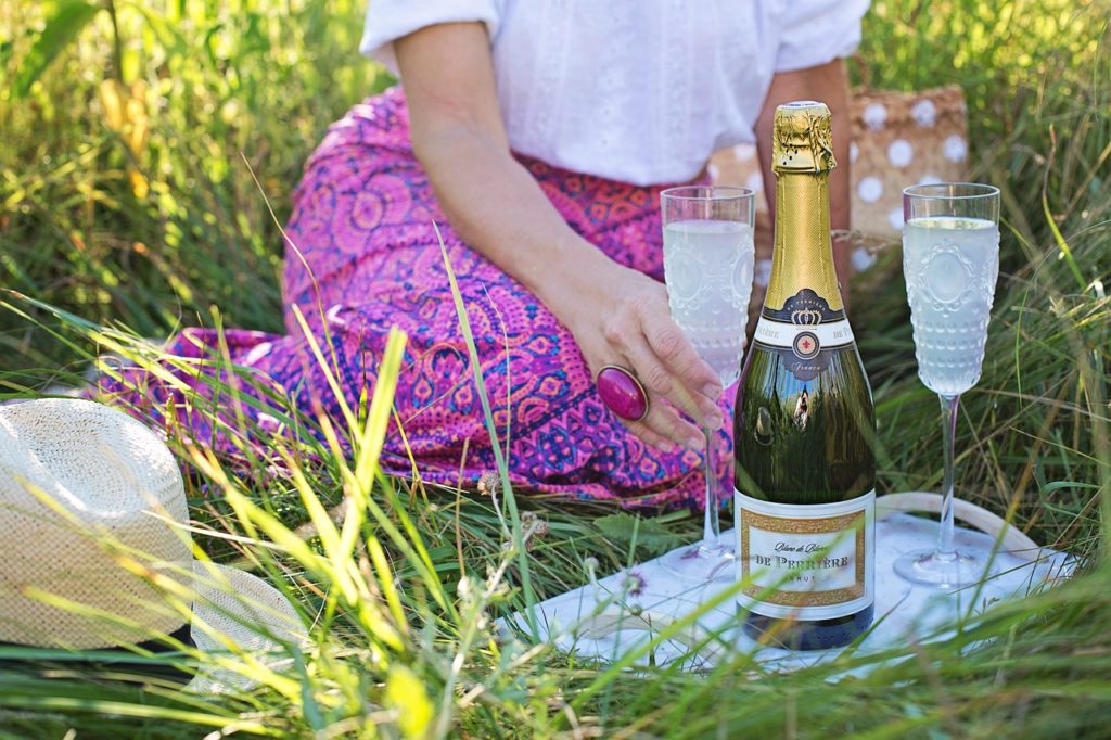woman picnicking with champagne